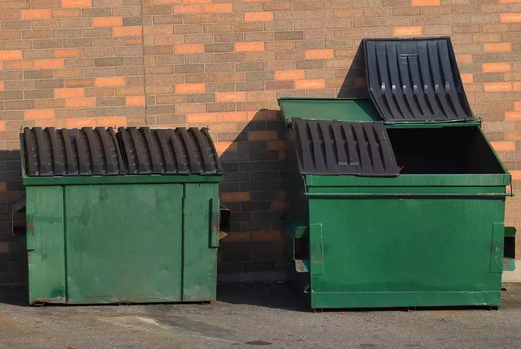 Green garbage dumpsters