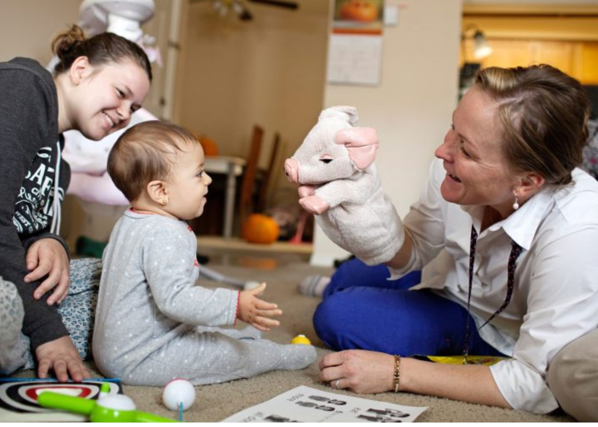A doctor visits a baby at home