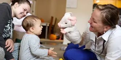 A doctor visits a baby at home