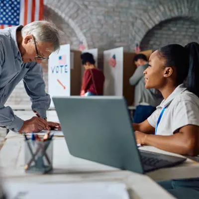 Election judge helps a voter register