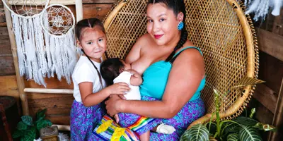 Woman breastfeeds her baby