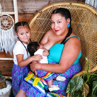 Woman breastfeeds her baby